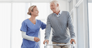 Home care aide helping senior patient